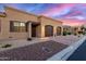 Beautiful home showcasing desert landscaping, a spacious three car garage, and an inviting front entrance at 4241 N Pebble Creek Pkwy # 28, Goodyear, AZ 85395