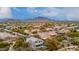 Aerial view of neighborhood with lush desert landscaping, community pool and mountain views at 4801 E Quien Sabe Way, Cave Creek, AZ 85331