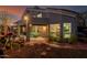 Backyard view highlighting the covered patio, picnic table, and lush garden leading to the home's interior at 4801 E Quien Sabe Way, Cave Creek, AZ 85331