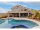 Backyard pool and patio with a built-in grill, outdoor seating, desert landscape, and two-story home at 4801 E Quien Sabe Way, Cave Creek, AZ 85331