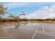 Community basketball court with wet pavement and lush desert vegetation in the background at 4801 E Quien Sabe Way, Cave Creek, AZ 85331