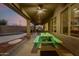 Covered patio featuring a picnic table with view of a barbeque area and a pool in the background at 4801 E Quien Sabe Way, Cave Creek, AZ 85331