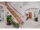 Inviting entryway featuring a wood staircase, neutral walls, tile flooring and bright natural light at 4801 E Quien Sabe Way, Cave Creek, AZ 85331