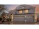 Frontal view of a two-car attached garage featuring stylish doors and manicured landscaping at 4801 E Quien Sabe Way, Cave Creek, AZ 85331