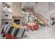 Charming living room with a stone fireplace, staircase, and ample natural light enhancing the inviting ambiance at 4801 E Quien Sabe Way, Cave Creek, AZ 85331