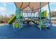 Community playground with blue rubber surface, covered play structure, slide, and climbing net at 4801 E Quien Sabe Way, Cave Creek, AZ 85331