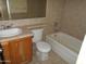 Functional bathroom featuring a vanity, toilet, and bathtub with tile surround at 5221 N 42Nd Ln, Phoenix, AZ 85019