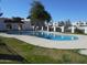 Community pool featuring clear water, surrounding green space, and a nearby cabana under a bright, sunny sky at 5221 N 42Nd Ln, Phoenix, AZ 85019