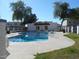 Outdoor community pool featuring clear water, surrounding grass area, and nearby buildings under a bright, sunny sky at 5221 N 42Nd Ln, Phoenix, AZ 85019