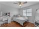 Bright bedroom with hardwood floors, ceiling fan, and vanity area at 5615 W Tonopah Dr, Glendale, AZ 85308