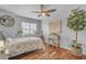 A serene bedroom featuring a cozy bed, natural light, and stylish décor, perfect for relaxation at 5615 W Tonopah Dr, Glendale, AZ 85308