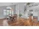 Bright dining area with hardwood floors, a staircase, and ample natural light from the large windows at 5615 W Tonopah Dr, Glendale, AZ 85308