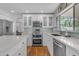 Modern kitchen with white cabinets, stainless steel appliances, and stylish backsplash, offering both beauty and functionality at 5615 W Tonopah Dr, Glendale, AZ 85308