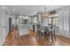 Bright kitchen featuring white cabinetry, hardwood floors, a center island, and stainless steel appliances at 5615 W Tonopah Dr, Glendale, AZ 85308