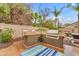 Outdoor kitchen with stainless steel grill, countertops, and bar seating at 5615 W Tonopah Dr, Glendale, AZ 85308