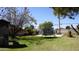 Green backyard with a trampoline and a playground set for outdoor fun at 6212 S 12Th St, Phoenix, AZ 85042