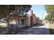 Quaint home featuring a covered porch, classic architecture, mature tree, and a paved driveway at 6212 S 12Th St, Phoenix, AZ 85042