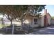 Charming front yard featuring mature trees and a cozy porch at 6212 S 12Th St, Phoenix, AZ 85042