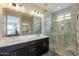 Luxurious bathroom with a dual-sink vanity, marble walk-in shower, and ample lighting for a spa-like retreat at 631 E Peach Tree St, Queen Creek, AZ 85140