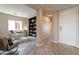 Inviting entryway featuring wood-look tile floors, and an adjacent office space with built-in shelves at 631 E Peach Tree St, Queen Creek, AZ 85140