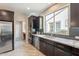 Modern kitchen featuring granite countertops, stainless steel appliances, and dark wood cabinetry at 631 E Peach Tree St, Queen Creek, AZ 85140