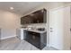 Spacious laundry room features custom cabinetry, granite countertops, and modern washer and dryer at 631 E Peach Tree St, Queen Creek, AZ 85140