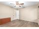 Bedroom with wood-look tile flooring, a ceiling fan, and an open doorway at 6829 S 58Th Ave, Laveen, AZ 85339