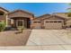 Charming single-story home featuring a three-car garage and desert landscaping at 6829 S 58Th Ave, Laveen, AZ 85339