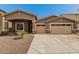 Attractive home exterior with a spacious driveway and a well-maintained front yard at 6829 S 58Th Ave, Laveen, AZ 85339