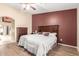 Cozy main bedroom with a wood-look tile floor and dark wood furnishings at 6829 S 58Th Ave, Laveen, AZ 85339