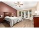 Spacious main bedroom featuring wood-look tile floors, ceiling fan and private patio access at 6829 S 58Th Ave, Laveen, AZ 85339