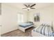 Sunny bedroom with wood-look floors, a ceiling fan, and two twin beds at 6842 N 10Th Pl, Phoenix, AZ 85014