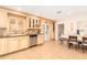 Well-lit kitchen and breakfast nook with custom cabinets, tile floors, and stainless steel appliances at 6842 N 10Th Pl, Phoenix, AZ 85014