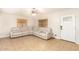 Cozy living room features tile floors, a ceiling fan, and a comfortable sectional sofa at 6842 N 10Th Pl, Phoenix, AZ 85014