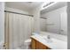 Bathroom featuring a shower with patterned curtain, toilet, sink and a mirror at 7317 W Southgate Ave, Phoenix, AZ 85043