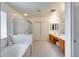 Bright bathroom featuring double vanity, large soaking tub, and shower with patterned floors at 7317 W Southgate Ave, Phoenix, AZ 85043