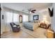 A comfortable bedroom featuring a queen bed, a cozy chair, and soft natural lighting at 7317 W Southgate Ave, Phoenix, AZ 85043