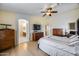 Light and airy bedroom with ensuite bathroom, hardwood floors, ceiling fan, and built-in storage at 7317 W Southgate Ave, Phoenix, AZ 85043