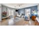 Light-filled bedroom with blue walls, hardwood floors, and a ceiling fan at 7317 W Southgate Ave, Phoenix, AZ 85043