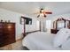 Bedroom with a four-poster bed, flat screen tv, and wooden dresser at 7317 W Southgate Ave, Phoenix, AZ 85043