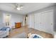 Cozy bedroom with hardwood floors, a ceiling fan, a dresser and large closet at 7317 W Southgate Ave, Phoenix, AZ 85043