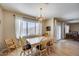 Cozy dining area with a wooden table, ample natural light, and neutral decor at 7317 W Southgate Ave, Phoenix, AZ 85043