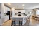 Modern kitchen with white cabinetry, stainless steel appliances, and a spacious island at 7317 W Southgate Ave, Phoenix, AZ 85043