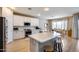 Bright kitchen with a large island, stainless steel appliances, and an adjacent dining area at 7317 W Southgate Ave, Phoenix, AZ 85043