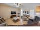 Bright living room with wood floors, comfortable seating, ceiling fan, and modern decor at 7317 W Southgate Ave, Phoenix, AZ 85043