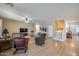 Spacious living room featuring light wood floors, comfortable seating, and a staircase leading to the upper level at 7317 W Southgate Ave, Phoenix, AZ 85043