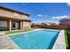 Backyard pool with artificial turf and covered patio, perfect for outdoor entertaining at 7317 W Southgate Ave, Phoenix, AZ 85043