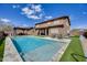 Lovely backyard pool with a covered patio, lounge chairs, and green artificial turf at 7317 W Southgate Ave, Phoenix, AZ 85043