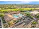 Aerial view of the community's pool, clubhouse, tennis courts and desert landscaping at 7361 E Rugged Ironwood Rd, Gold Canyon, AZ 85118