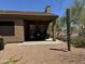 Backyard showcasing a covered patio, desert landscaping, and a mature Saguaro cactus at 7361 E Rugged Ironwood Rd, Gold Canyon, AZ 85118